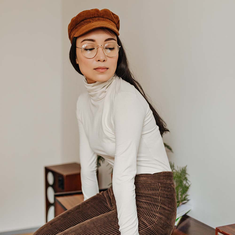 brunette-girl-in-glasses-is-sitting-on-wooden-tabl2-Z6VB9YK.jpg